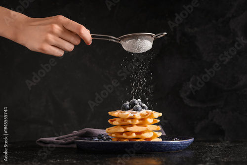 Woman sprinkling tasty home...