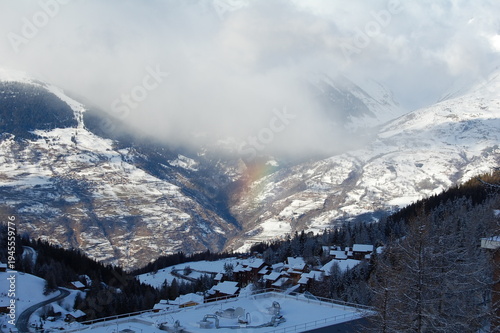 Alpine village in snowy mountain valley