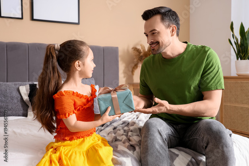 Little daughter giving fath...