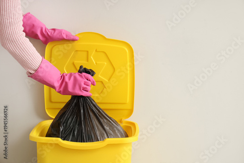 Woman taking garbage bag fr...