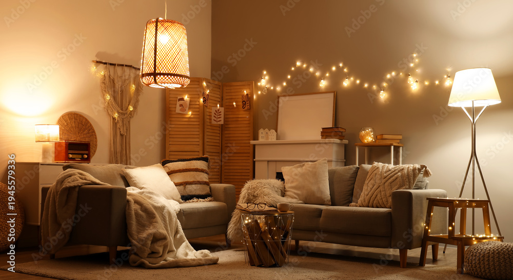 Obraz premium Interior of living room with sofas and glowing lights at night