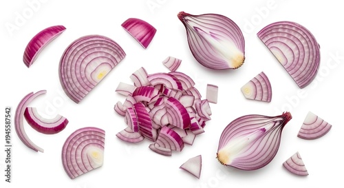 A red onion is sliced into various shapes, including rings and diced pieces. The onion segments are scattered on a white surface.