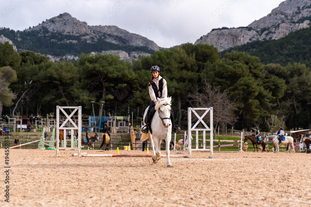 Obraz premium Horse riding - portrait of lovely equestrian on a white horse