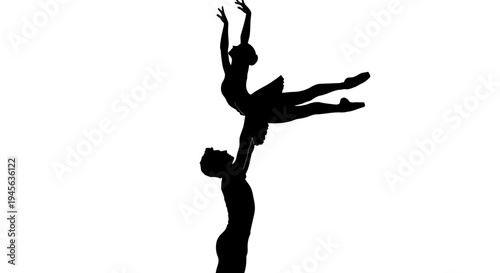 Silhouette of ballet dancers performing a lift in elegant pose.