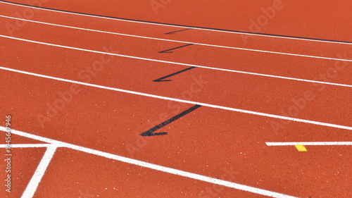 White a black lane markings on red running track texture sports background