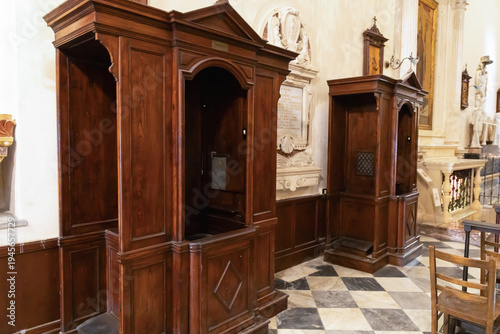 Photos Wooden confession booths inside catholic church interior.
