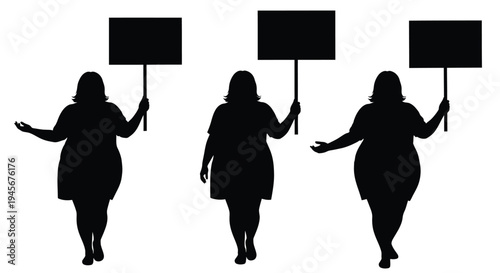 Three women holding protest signs a striking black silhouette