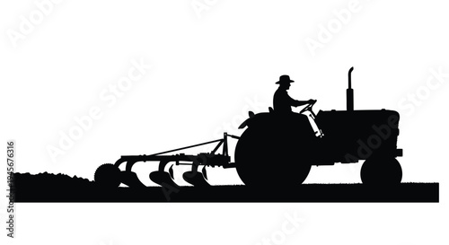 A farmer driving a vintage tractor through a field silhouette
