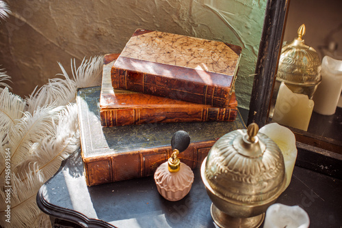 Vintage Dressing Table Details. Antique Books, Silver Hand Mirror, and Retro Perfume Bottle