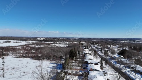 An aerial drone view of houses in winter