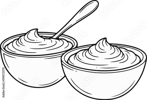 Two bowls of creamy dessert or dip with a spoon