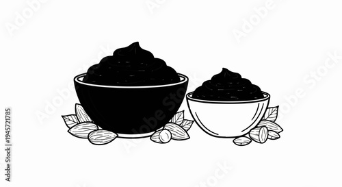 Two bowls of dark spread with almonds and leaves