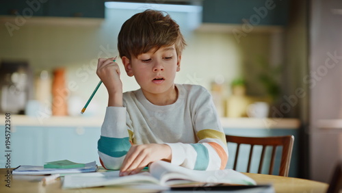 Obraz na plátne Elementary school student writing copybook making homework assignment closeup