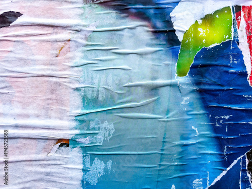 Layers of old colorful posters on wall damaged by time for your grunge style design