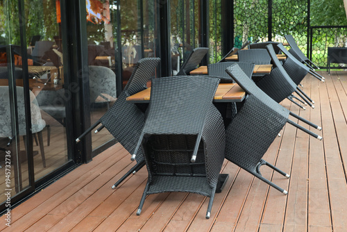 Modern outdoor dining set rests on wooden deck