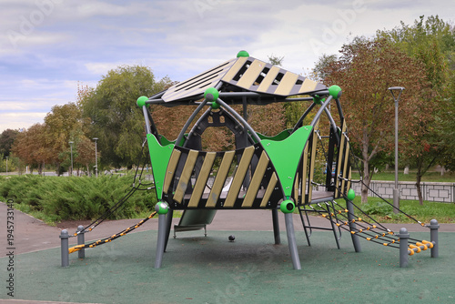 Bright green jungle gym stands in park