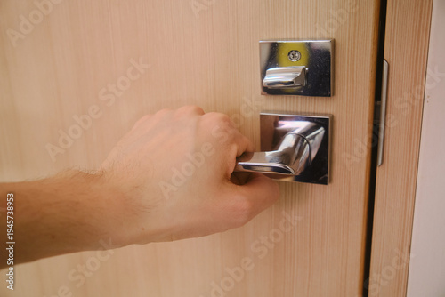 A hand on a door handle