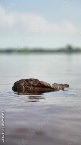 Single Rock in Calm Ocean Water