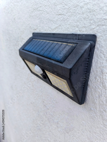 close view of a solar powered lantern in a white wall