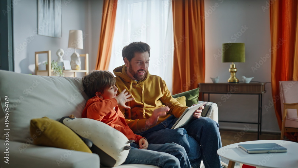 Fototapeta premium Father boy video calling talking tablet web camera sitting home couch closeup.