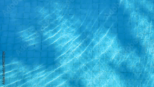 Pool water reflecting the sun and creating ripples.