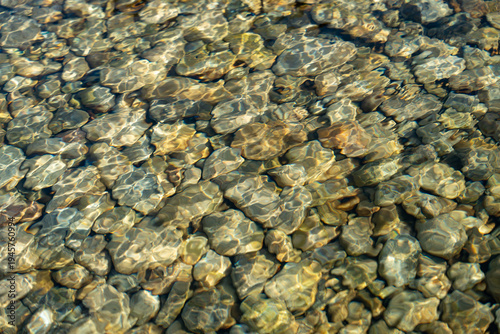 Photography Clear water reveals smooth, rounded stones beneath