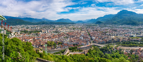 Elevated panoramic view of city of Grenoble. Summer cityscape with backdrop of French Alps, Isere, France
