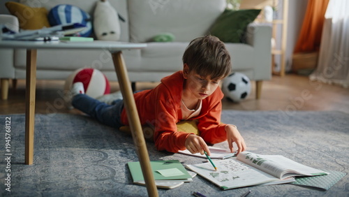 Fotografía Preteen boy learning homework in living room closeup