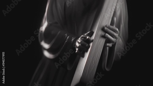 Close Up of Jesus Christ Figurine Carrying The Holy Cross For Religious Easter Content. White Figurine Hands Carrying Heavy Cross. Spiritual Concept of Lent and Good Friday, Easter Sacrifice.