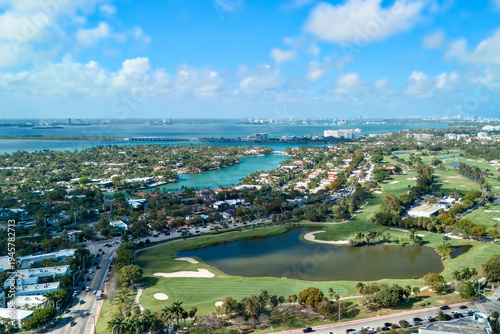 Drone aerial view of golf course lakes and coastal neighborhood Miami Beach