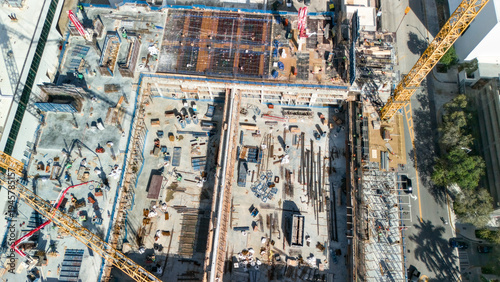 Drone aerial top view of active construction site with tower cranes in Miami Beach urban development area