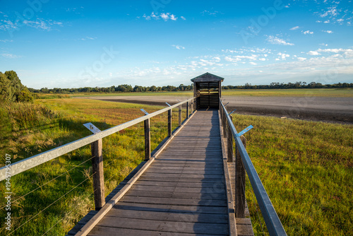 Wooden boardwalk leading to shelter over dry Bibra Lake bed, 1 April 2021, Perth, Australia