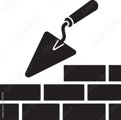 Black silhouette of trowel placing a brick on a wall also transparent background