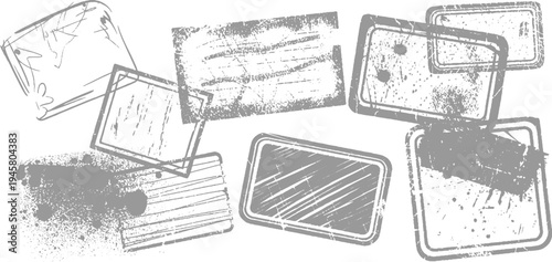 Collection of distressed grey rectangular and square rubber stamps with textured ink marks and scratches