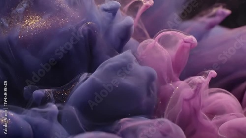 Abstract swirls of purple and pink ink with golden glitter particles