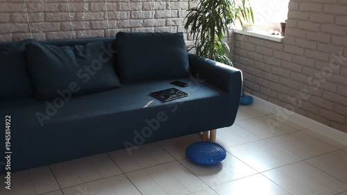 a tablet and a smartphone are lying on the sofa in the room