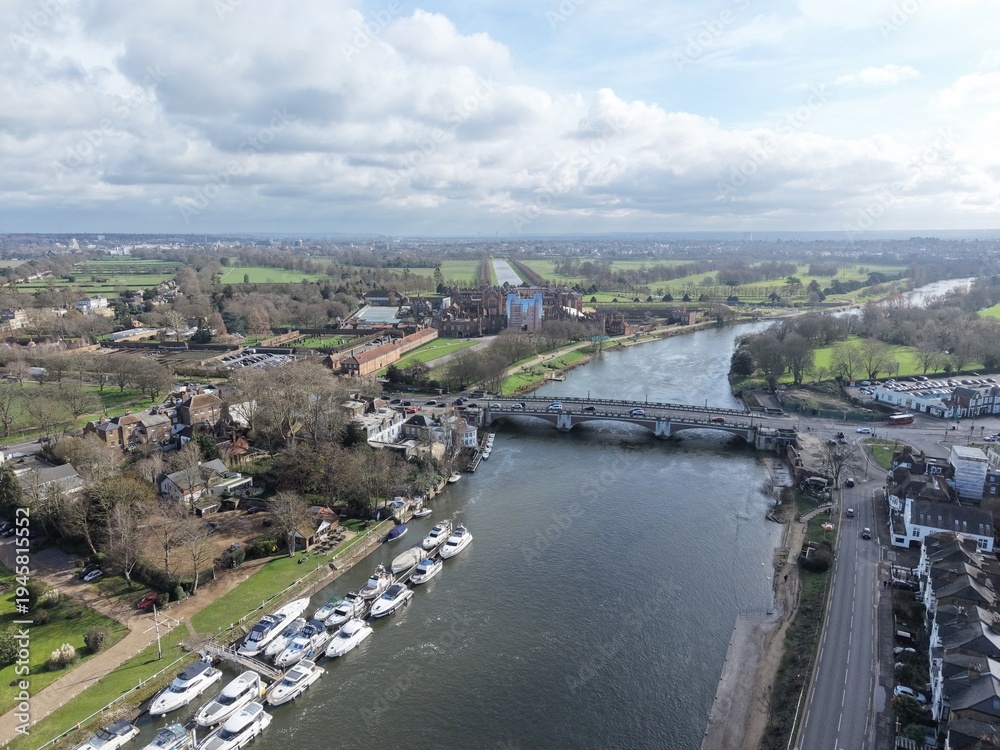 Fototapeta premium Hampton Court road bridge over Thames Surrey UK drone,aerial boats moored on river bank