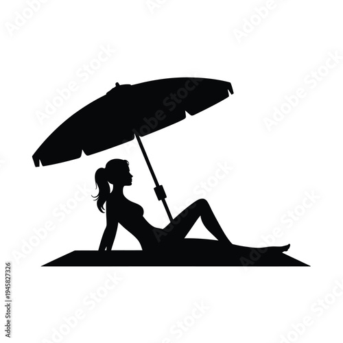 Silhouette of a woman relaxing under an umbrella on the beach