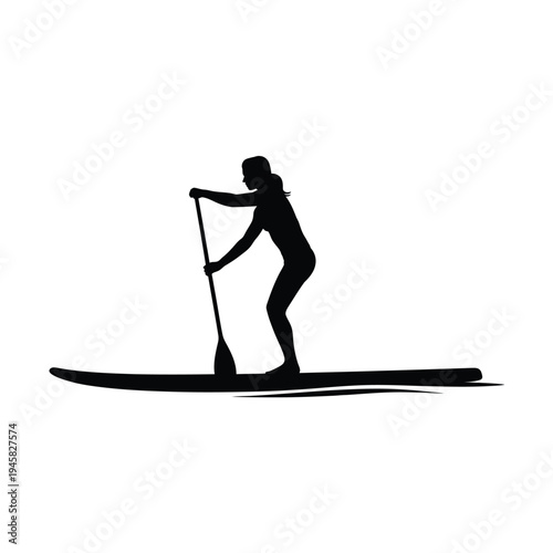 Silhouette of a woman stand up paddleboarding on calm water