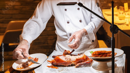 Foto Chef preparing Peking duck with care at a dining table during an evening meal