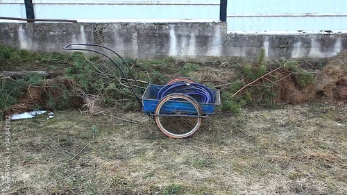 A metal garden cart on a lawn in spring