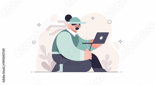 Person wearing cap and glasses, seated on floor, working on laptop