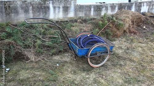 A metal garden cart on a lawn in spring