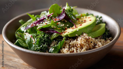 Close-up of Fresh Vegan Salad Bowl with Quinoa, Sliced Avocado, Mixed Greens, and Chili Flakes