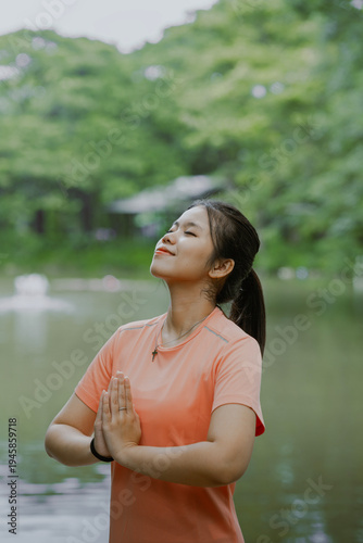 Young asian woman practicing yoga on nature. Girl meditating outdoors. Female with slim, strength and flexibility body. Healthy lifestyle. Vitality, calmness, relax, mindfulness and zen energy concept