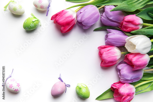Colorful easter eggs and tulips creating spring border