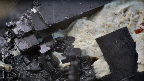 Macro image of perovskite black cubic crystal embedded in calcite white matrix from Khatanga River, Siberia, via microscope, 10x magnification, 3.6mm field of view