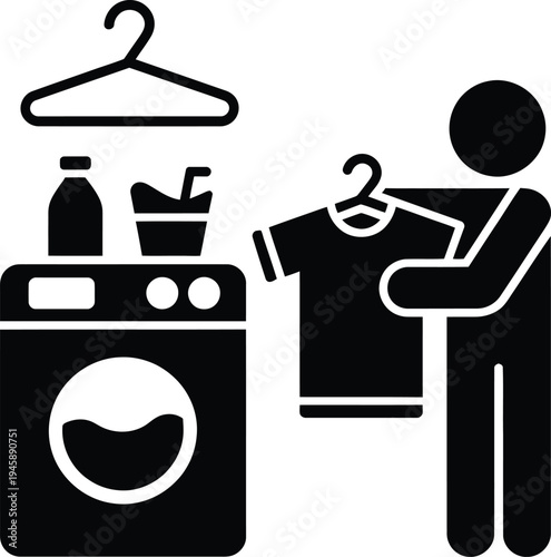 Person operating a washing machine with laundry items