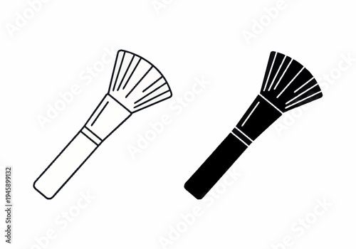 Two makeup brushes lie on a surface in a beauty salon environment for application.