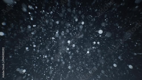 Flying through space dust motes dynamic motion abstract dark background with bokeh effect